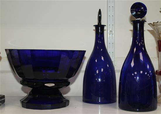 A pair of Bristol blue glass mallet shaped decanters and target stoppers, and a similar panel cut pedestal bowl, first half 19th centur